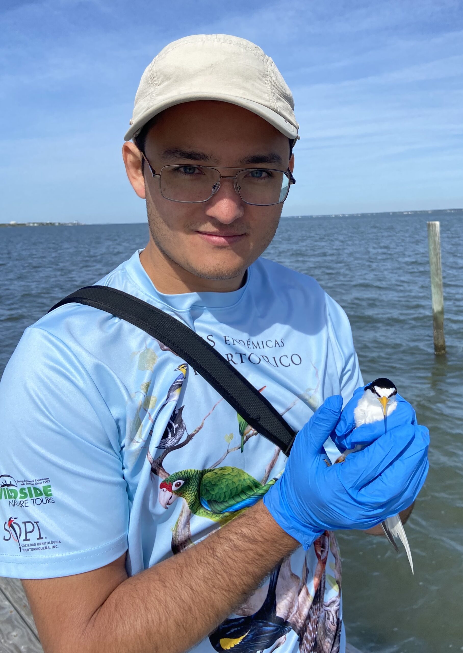 image: Juan Zuluaga holding bird.