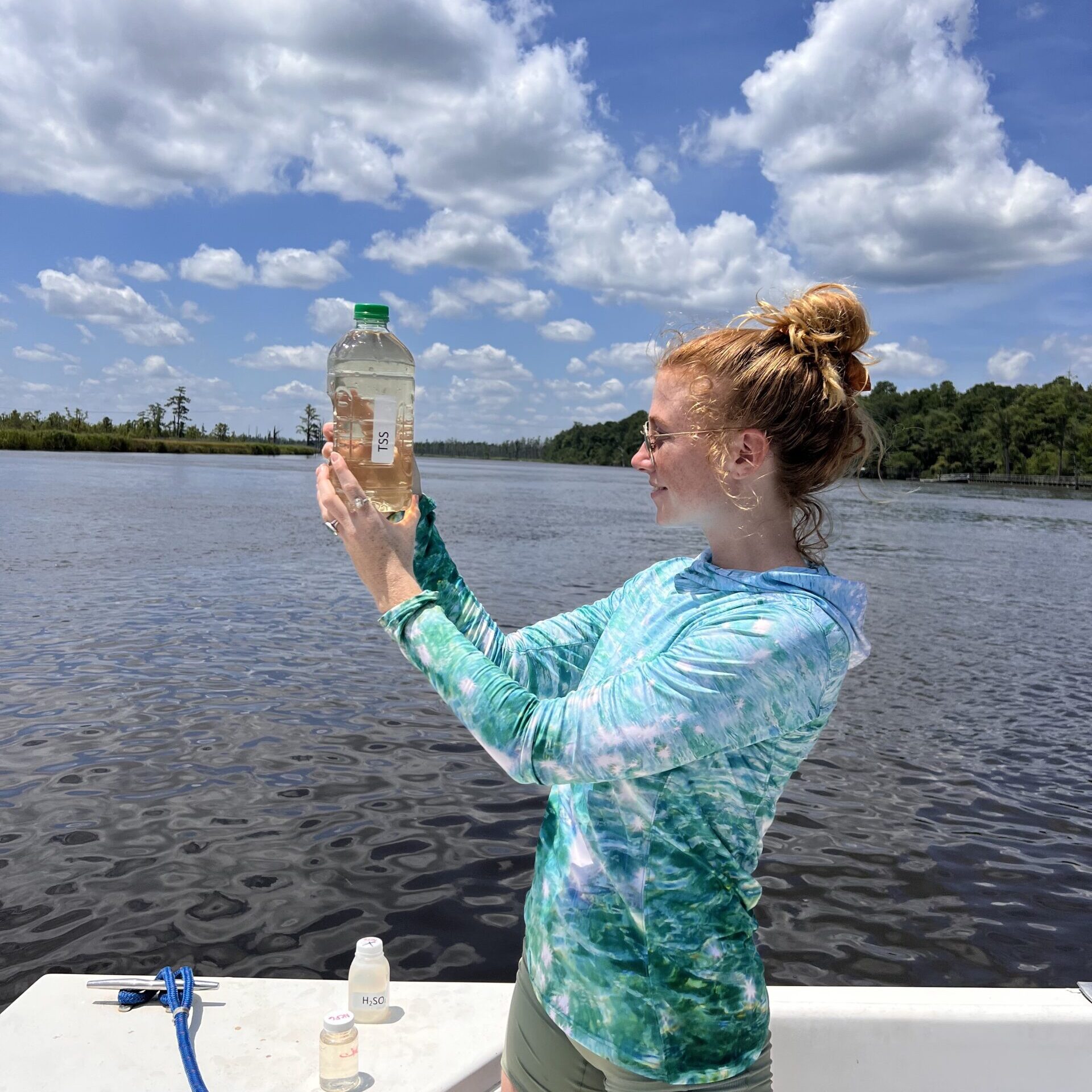 Colleen holds a bottle filled with water sample