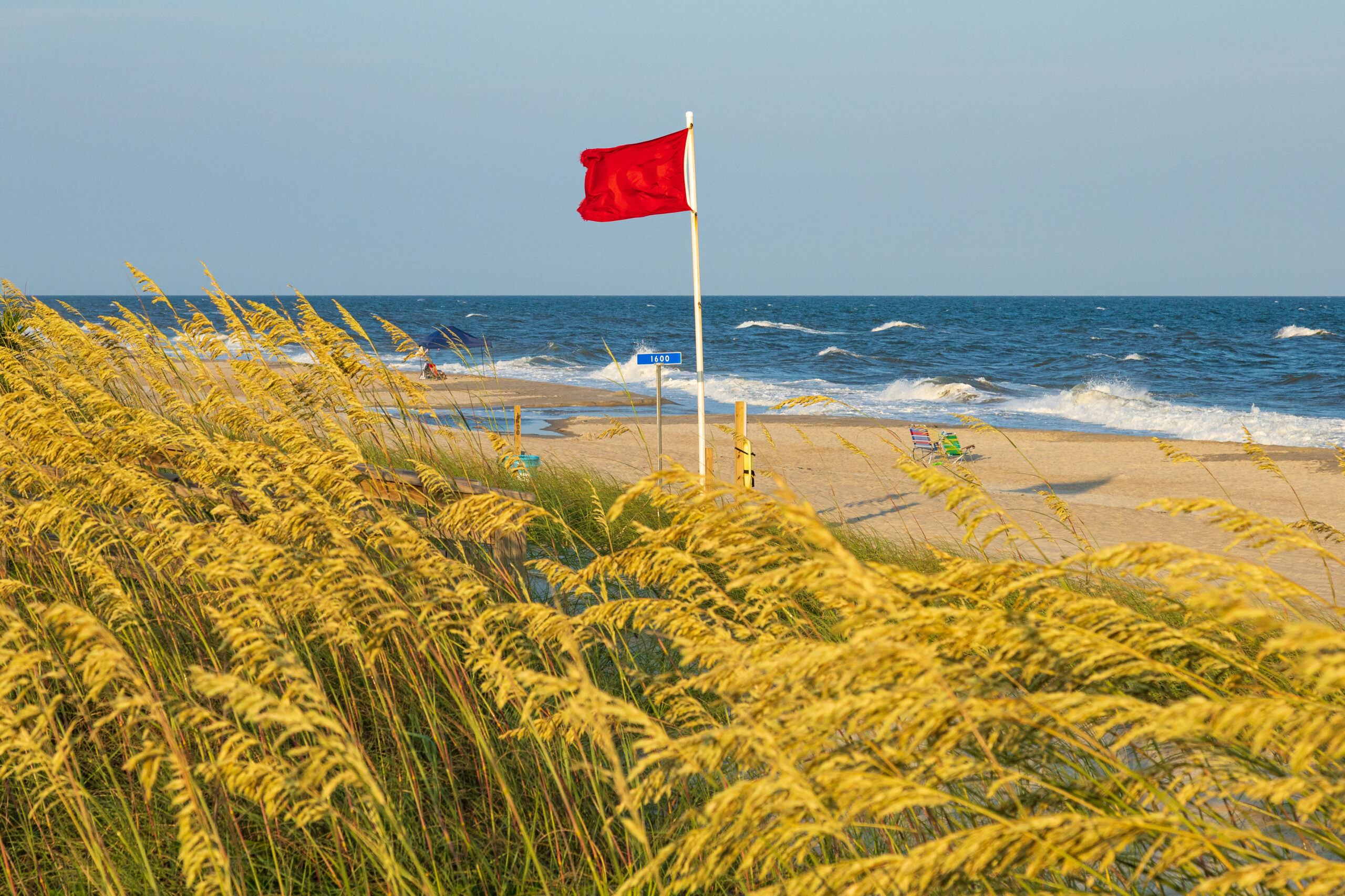 Red flag riptide warning on the beach