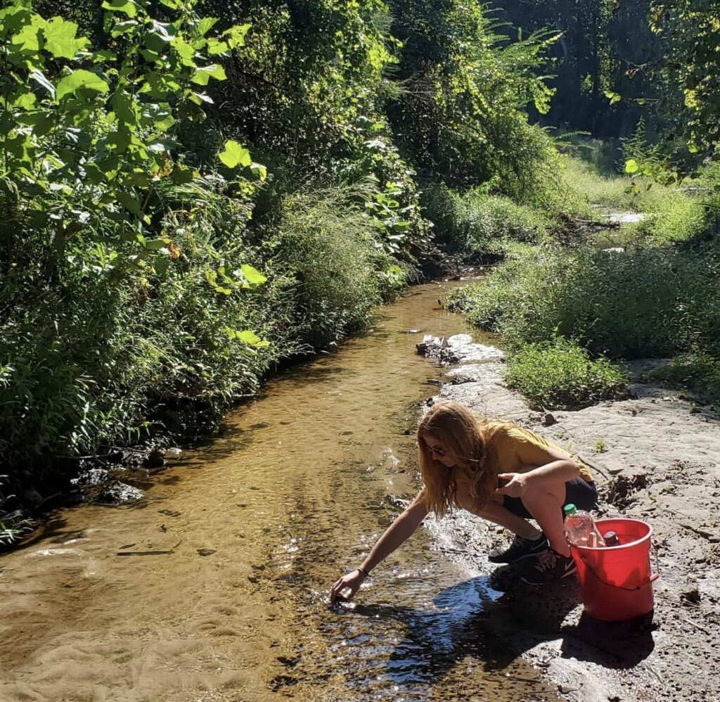 Colleen Brown samples a stream.
