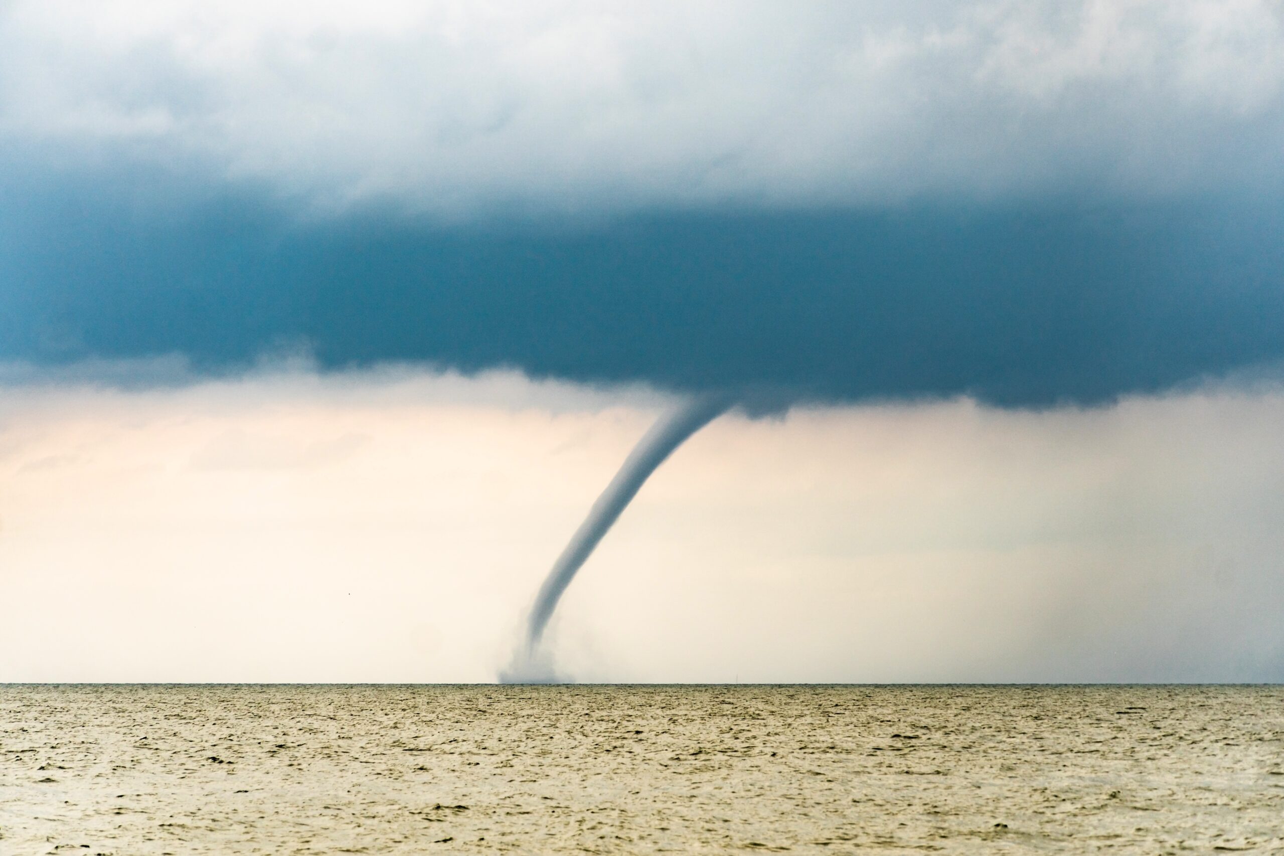 image: water spout over the sea.